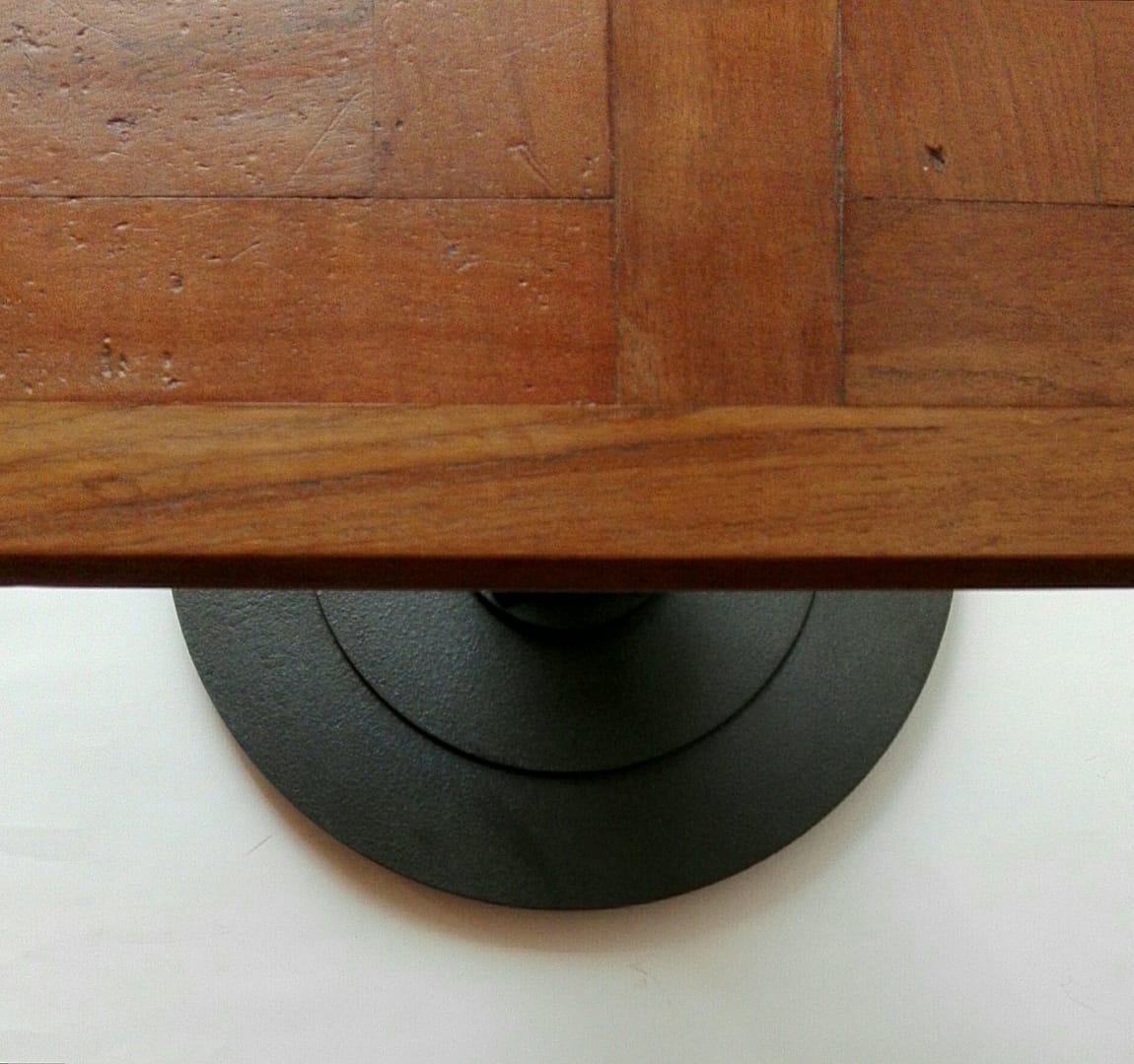 Table created from reclaimed parquet on cast iron pedestal base