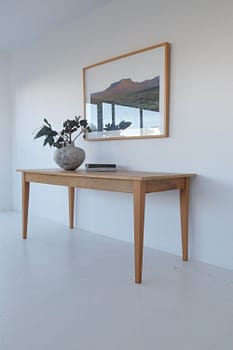 Photo of reclaimed yellowwood table with vase